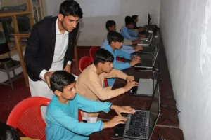 orphans learning computer in hayat orphanage